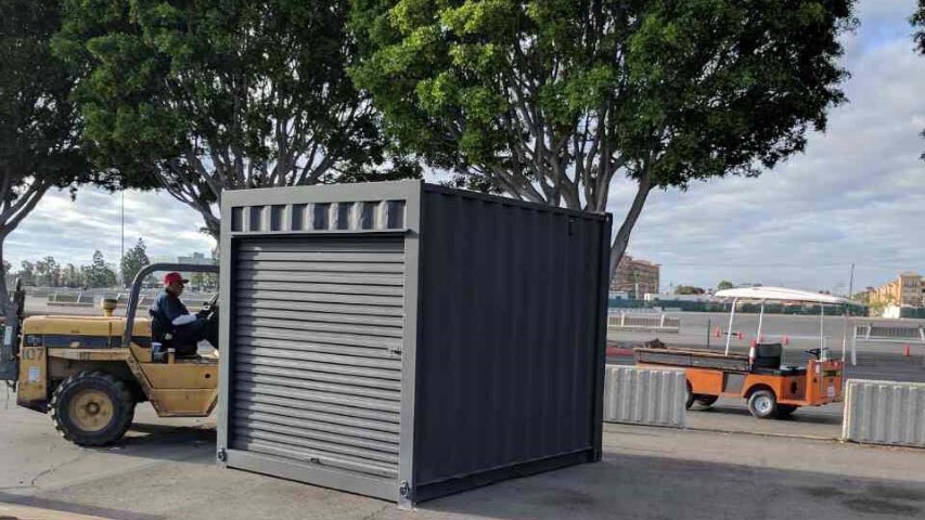 trees container shipping container black storage container with roll up door on field