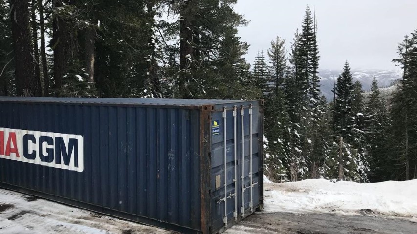 shipping containers with snow cold mountain snow mountain cloudy pine trees storage container