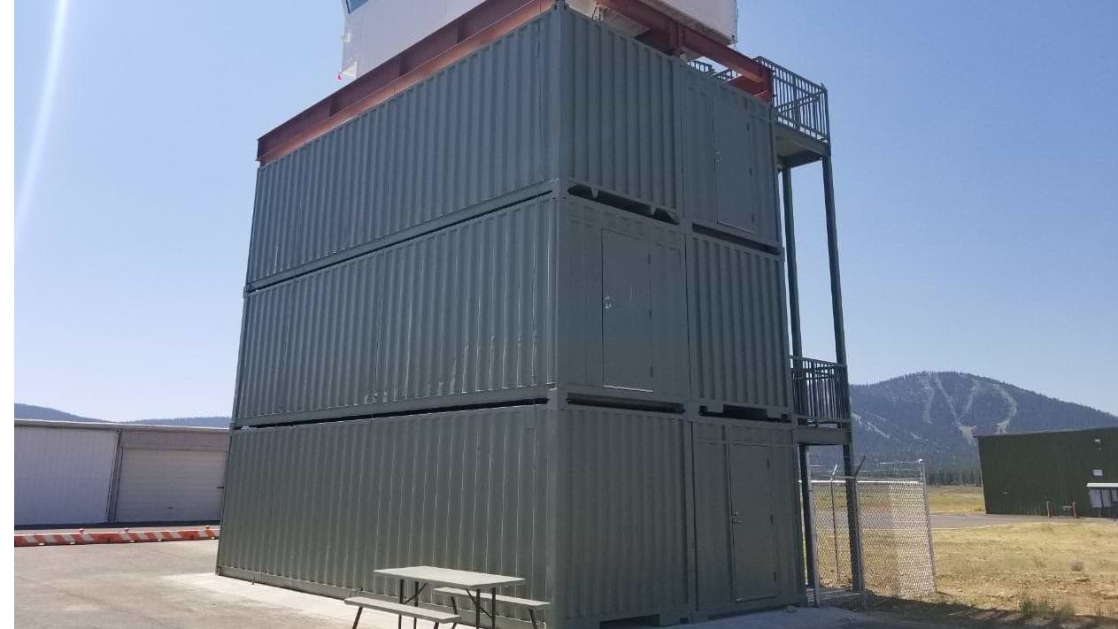 airport tower Truckee California shipping containers stacked on top of each other blue Sky