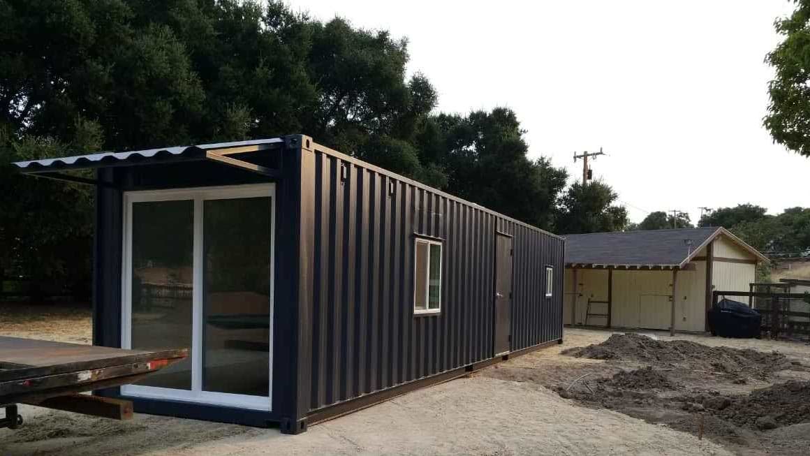black storage container container home modified container grey sky black color