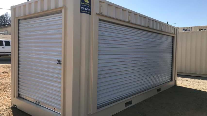 roll up door garage door shipping container storage container cream color conexwest sticker blue sky dirt road container