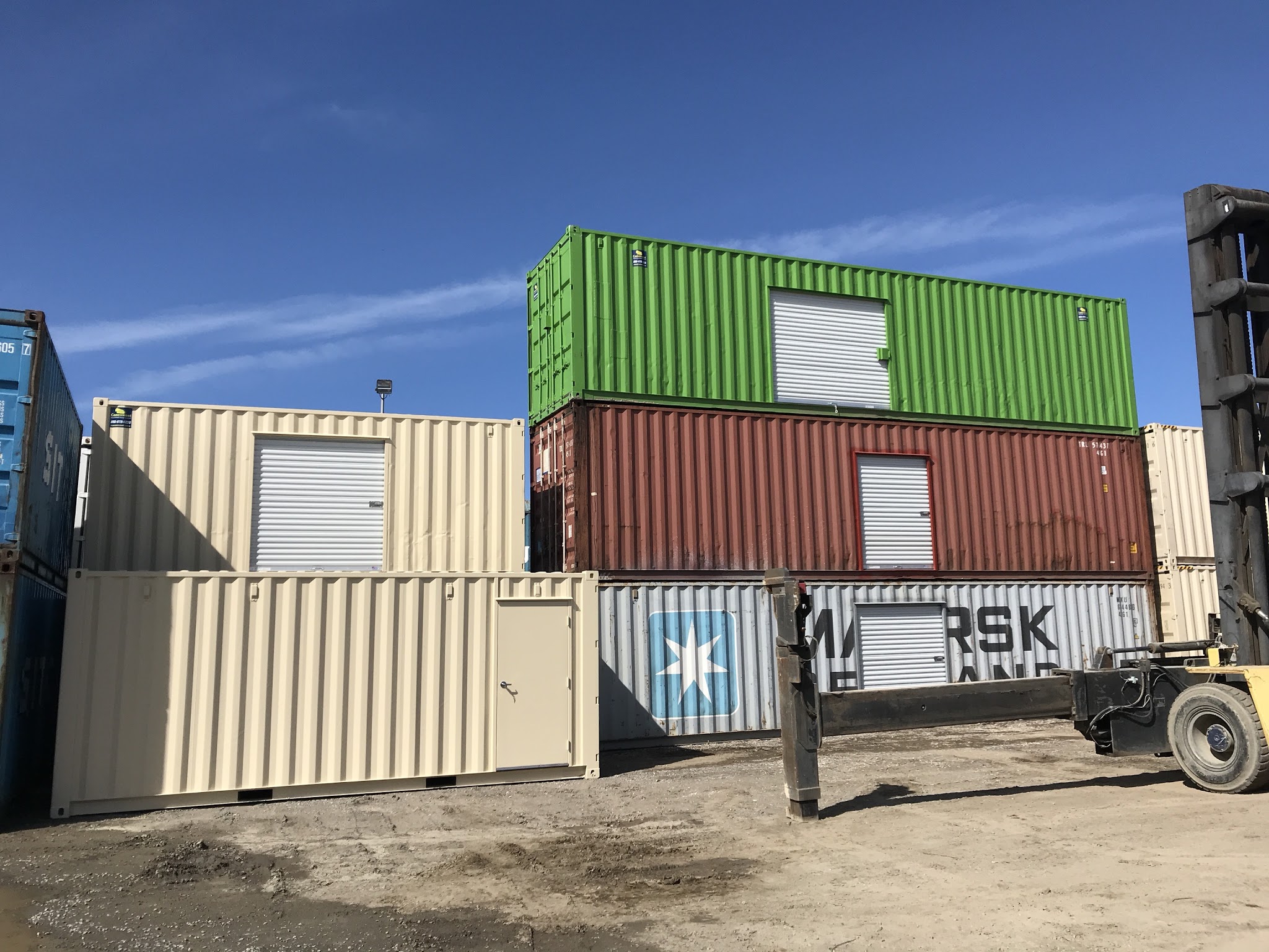 Roll-Up doors of shipping containers stacked on top of each other