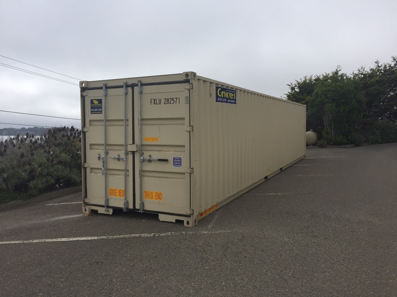 Shipping container on the side of the road with cargo doors