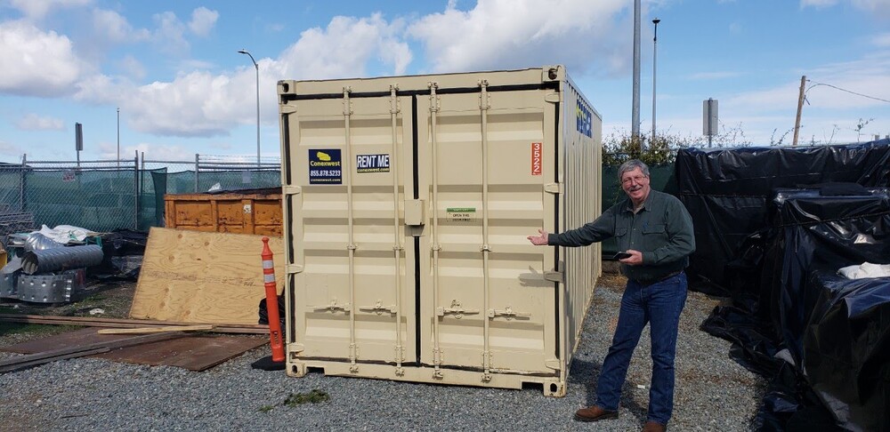 rent storage container man next to 20ft beige storage container from Conexwest